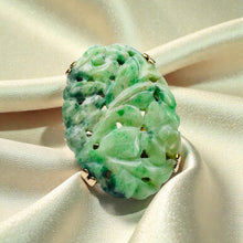 Load image into Gallery viewer, May include: A carved jade ring with a floral design. The ring features a large, oval-shaped jade stone in shades of green, with intricate leaf and flower carvings. The jade is set in a gold band with small gold accents. Antique 10K Gold Carved Nephrite Jade Ring – Hand Carved Jade Floral Motif – Art Nouveau Era Statement Ring – Estate Jade Jewelry